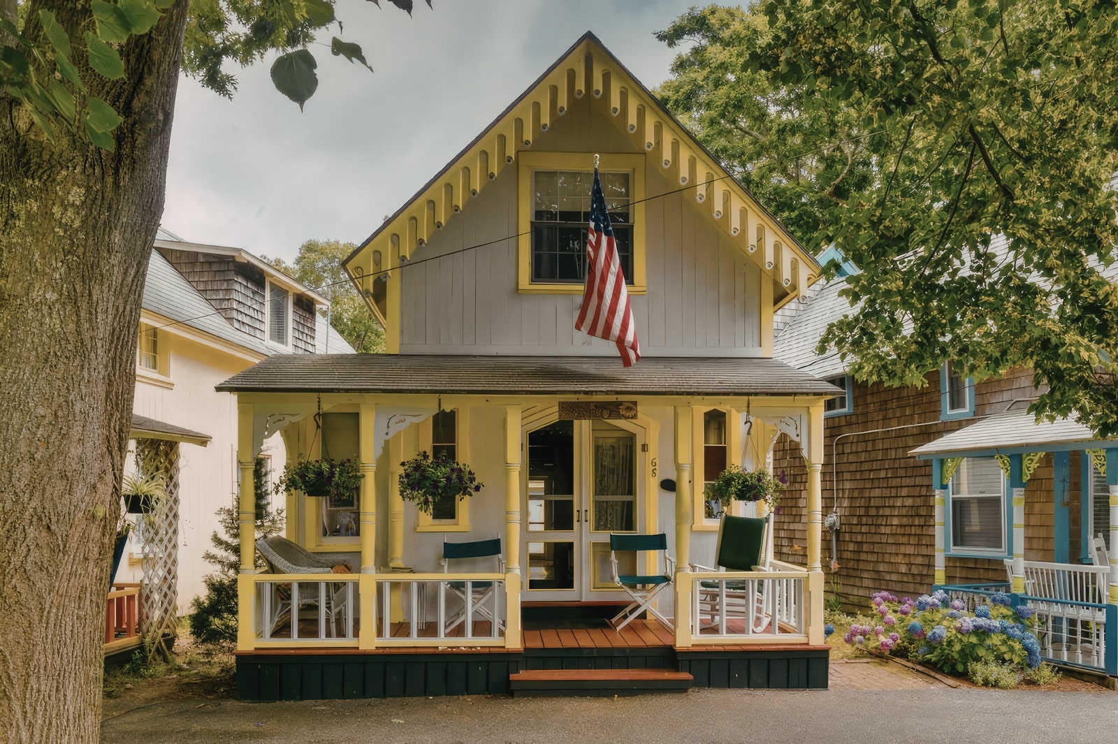 Small green house with porch and American flag in Milo-Grogan, Columbus Ohio