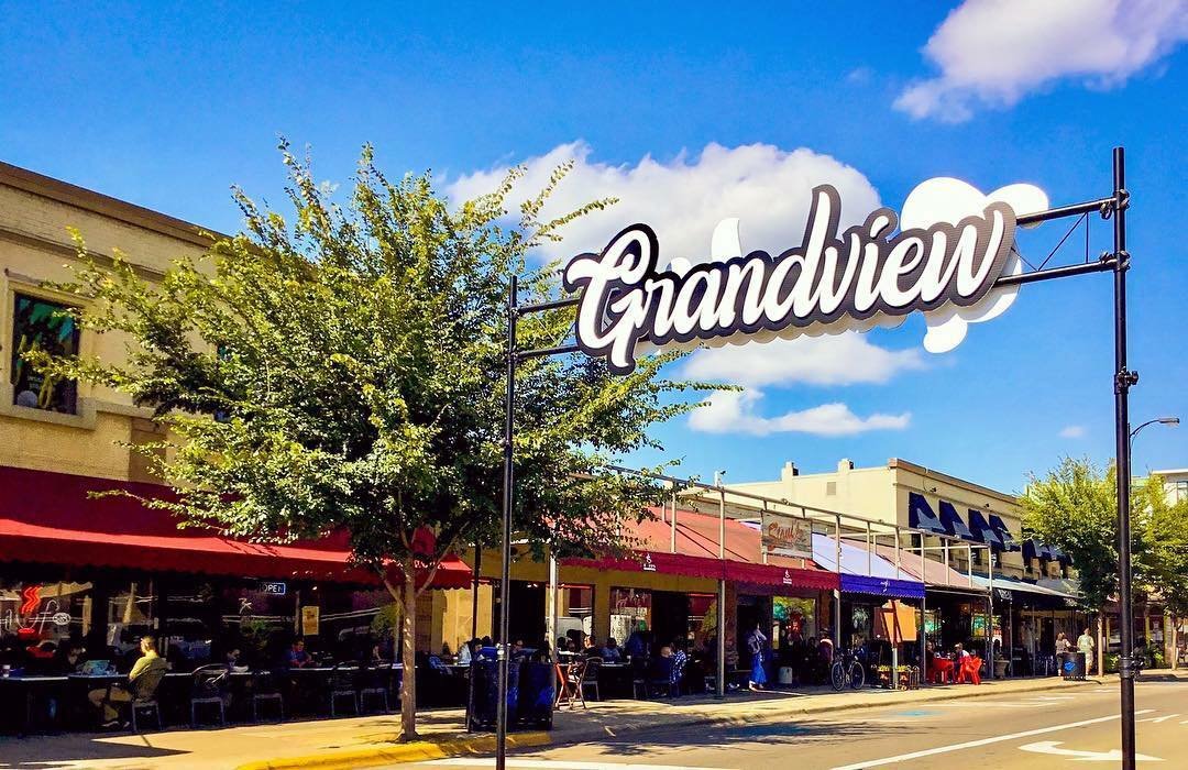 Grandview Heights neighborhood sign over a commercial street lined with shops, Central Ohio